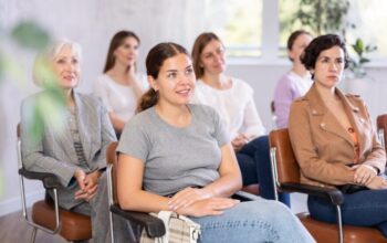 Young,Smiling,Woman,In,Casual,Clothes,Listening,To,Speaker,Lecture